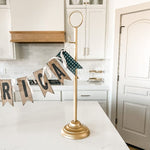 Party garland stand styled for a holiday buffet table